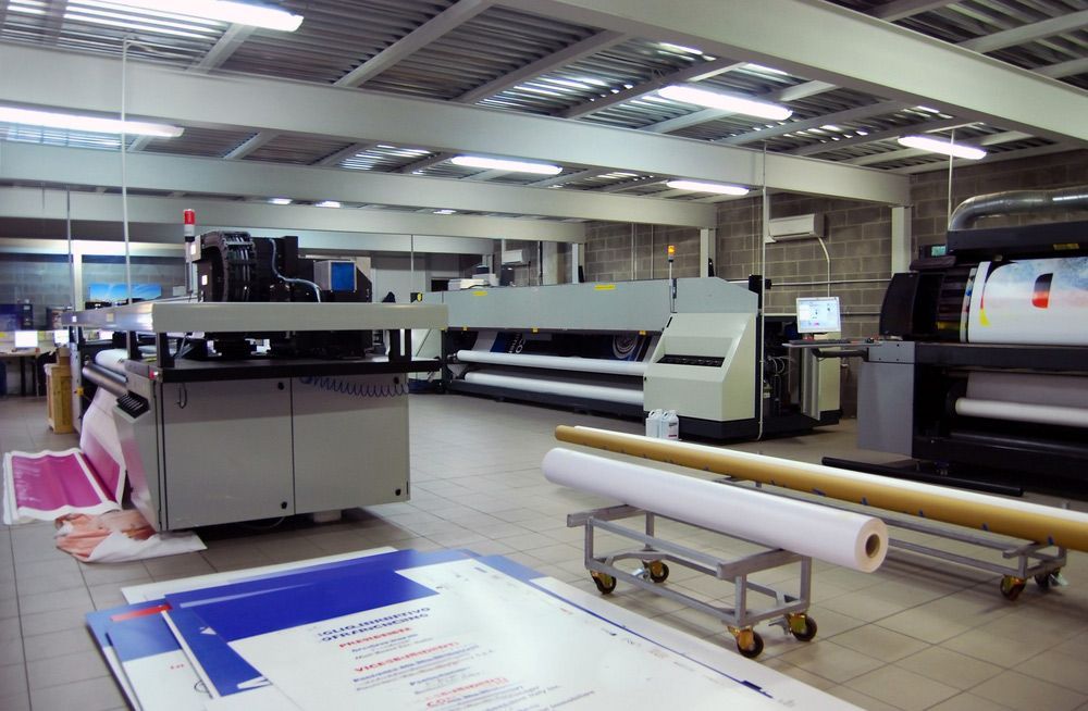 Large Room With a Lot of Machines and Papers on the Floor — Classic Design & Print in Bundaberg, QLD