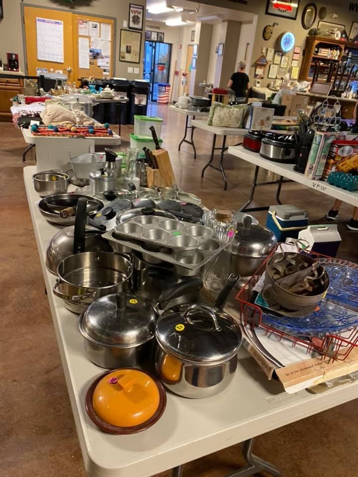 A table with a lot of pots and pans on it.