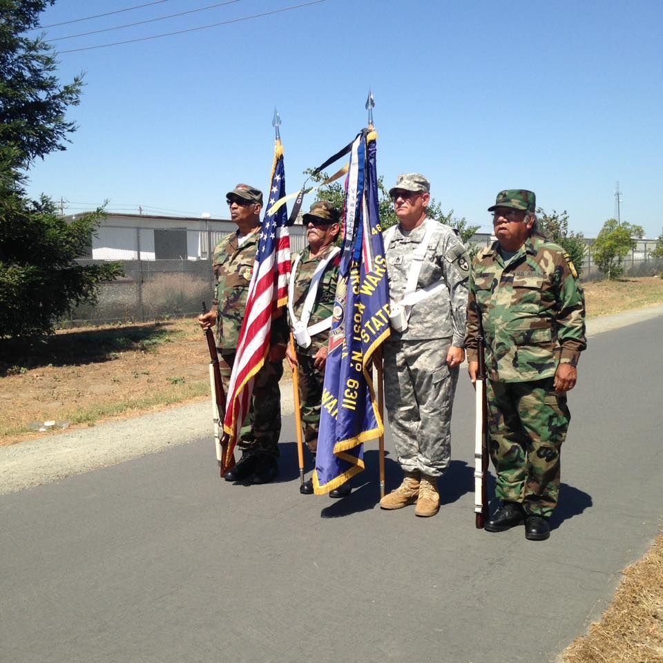 A group of soldiers holding flags one of which has the word army on it