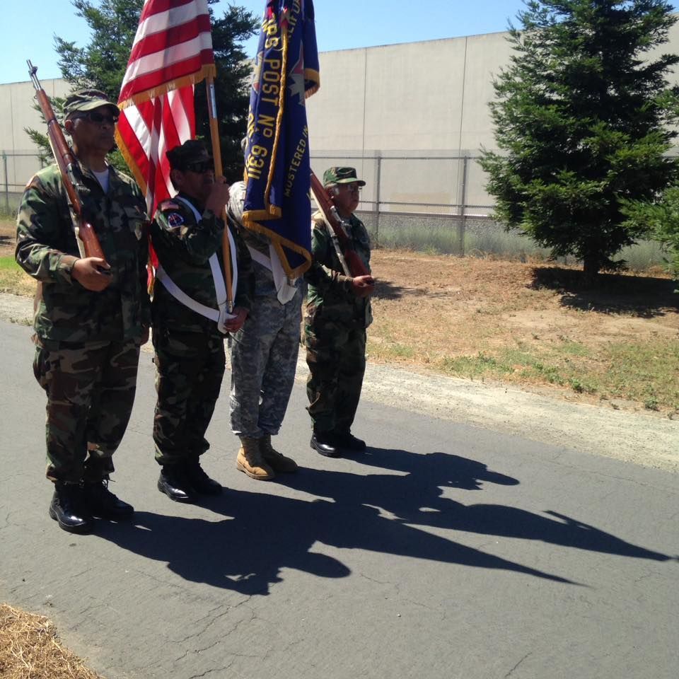 A group of soldiers holding flags one of which has the word coast on it
