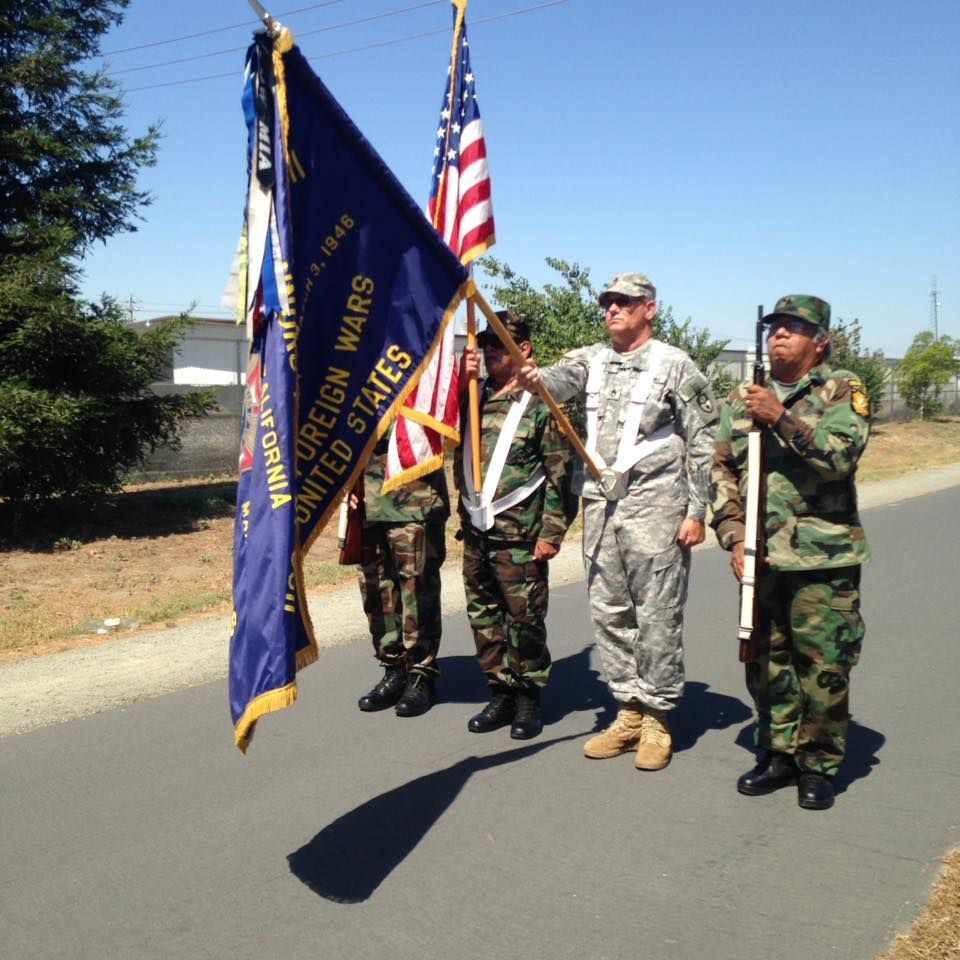 A group of soldiers holding a flag that says united states foreign wars