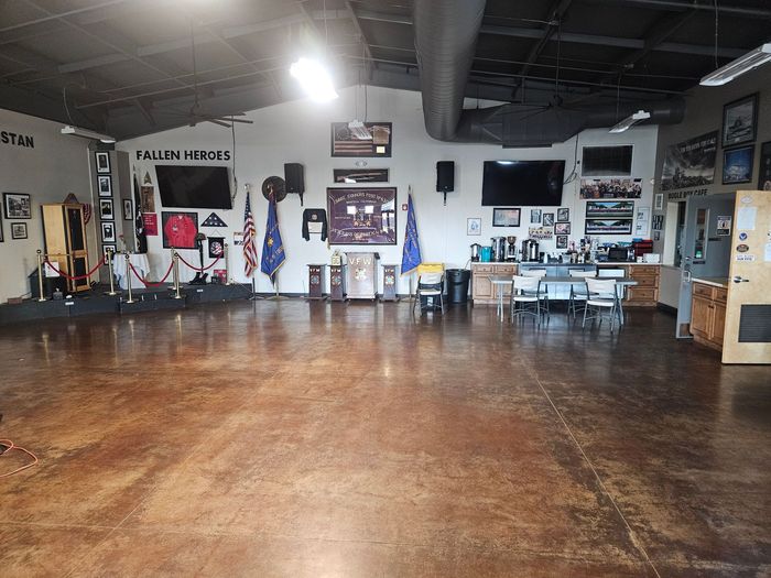 A large room with a wooden floor and white walls