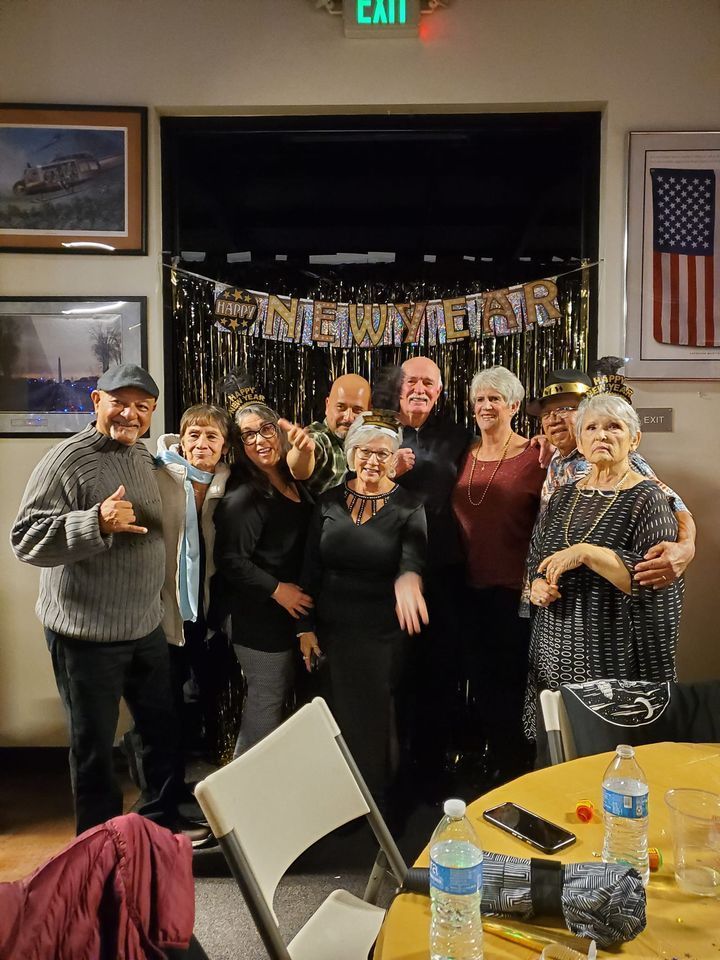 A group of people are posing for a picture in a room.