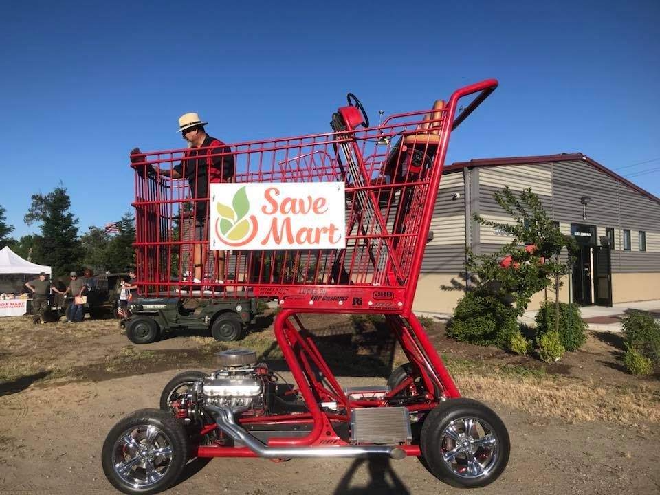 A red shopping cart with a sign that says save mart