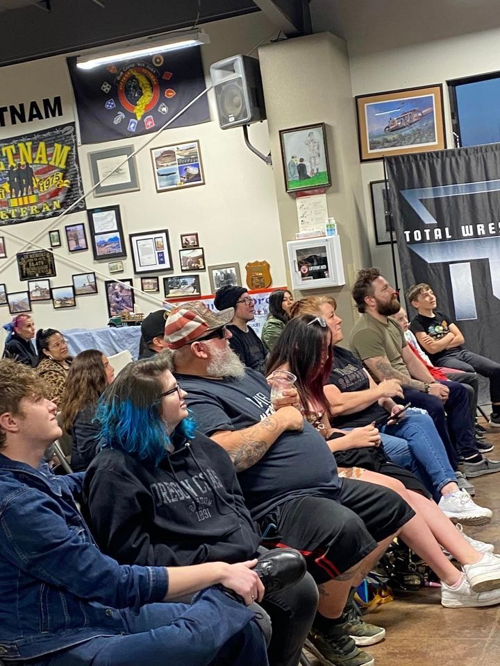 A group of people are sitting in a room watching a presentation.