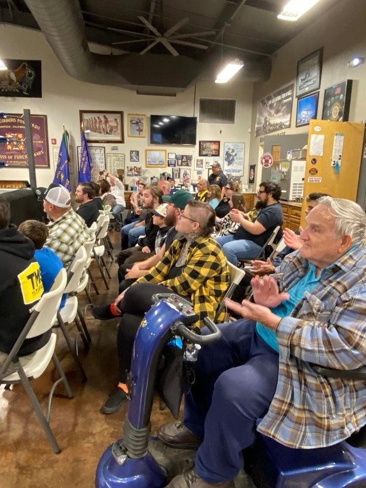 A group of people are sitting in chairs in a room.