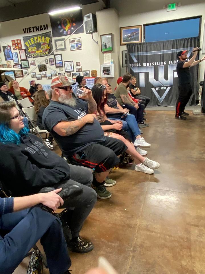 A man is giving a presentation to a group of people sitting in a room.