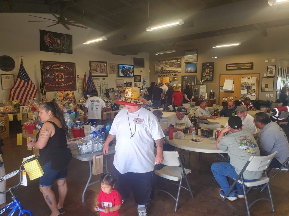 A group of people are sitting at tables in a room.
