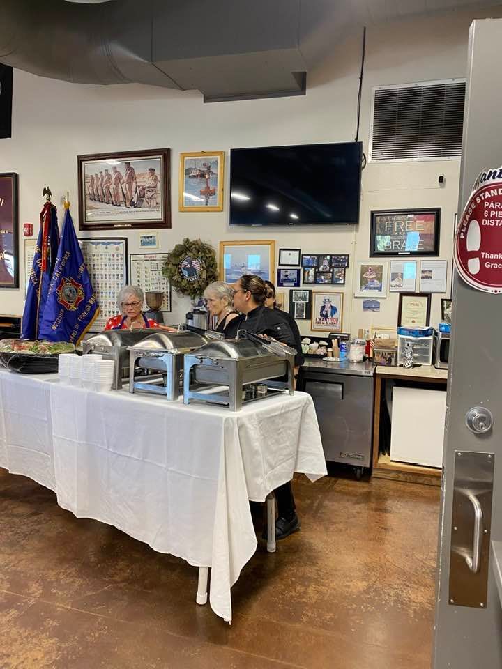 A group of people are sitting at a table in a room.
