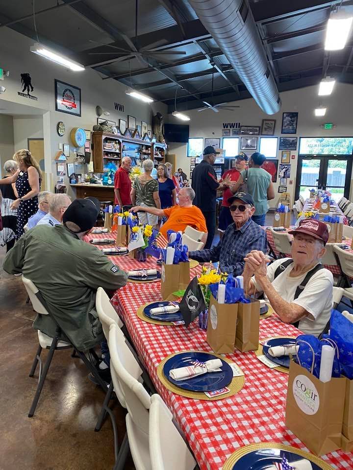 A group of people are sitting at tables in a room.