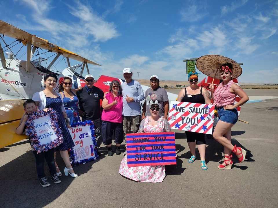 A group of people holding signs that say we salute you