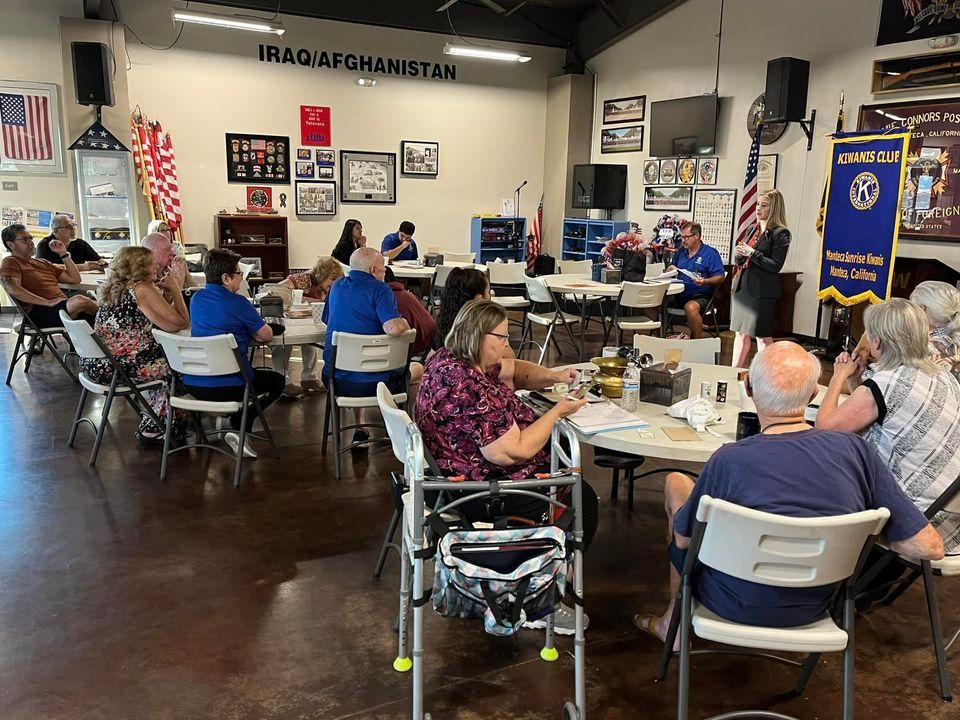 A group of people are sitting at tables in a room.