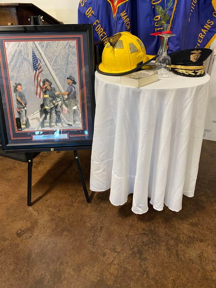 A table with a picture of firefighters and a helmet on it.