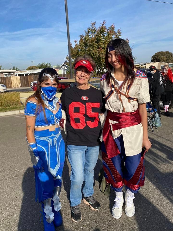 A group of people dressed in costumes are posing for a picture.