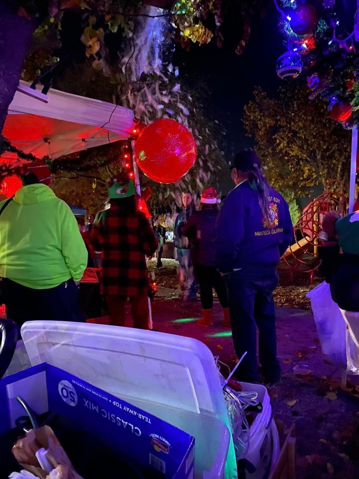 A group of people are standing around a cooler at a halloween party.