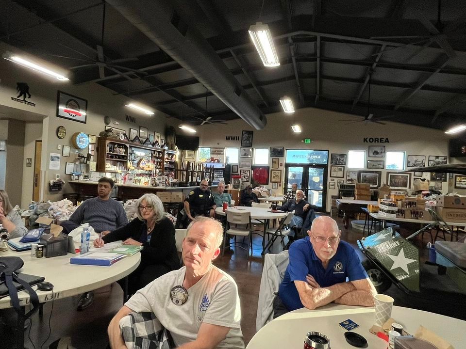 A group of people are sitting at tables in a room.