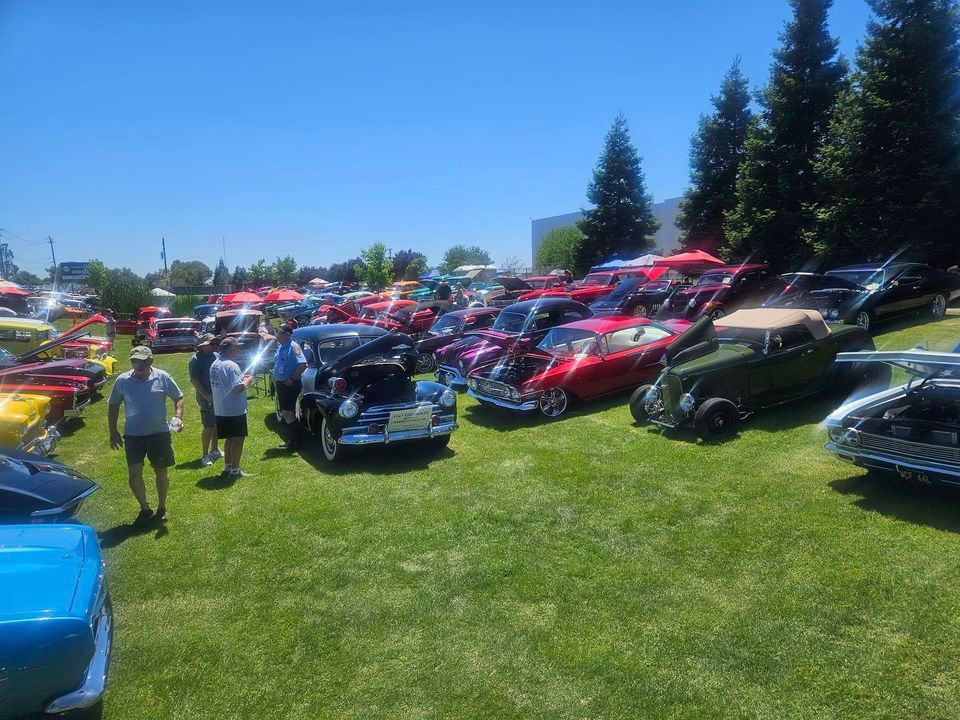 A lot of cars are parked in a grassy field