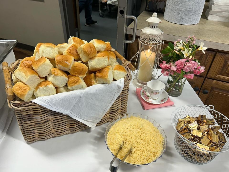 A table with a basket of biscuits and a bowl of rice