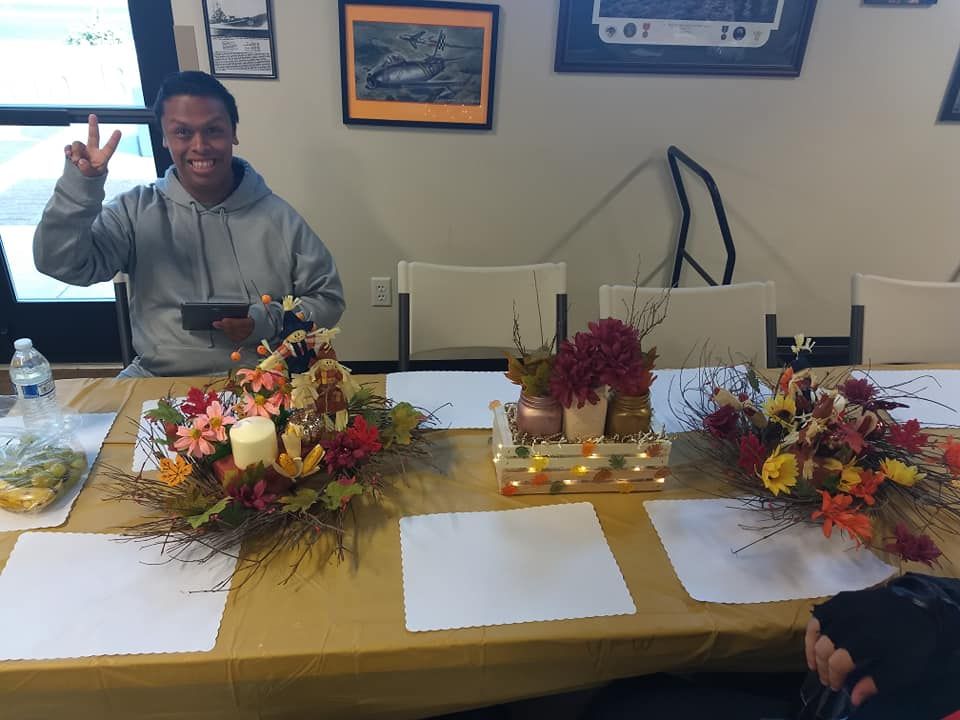 A man is sitting at a table with flowers on it