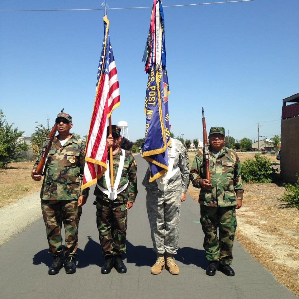 A group of soldiers holding flags one of which has the word post on it