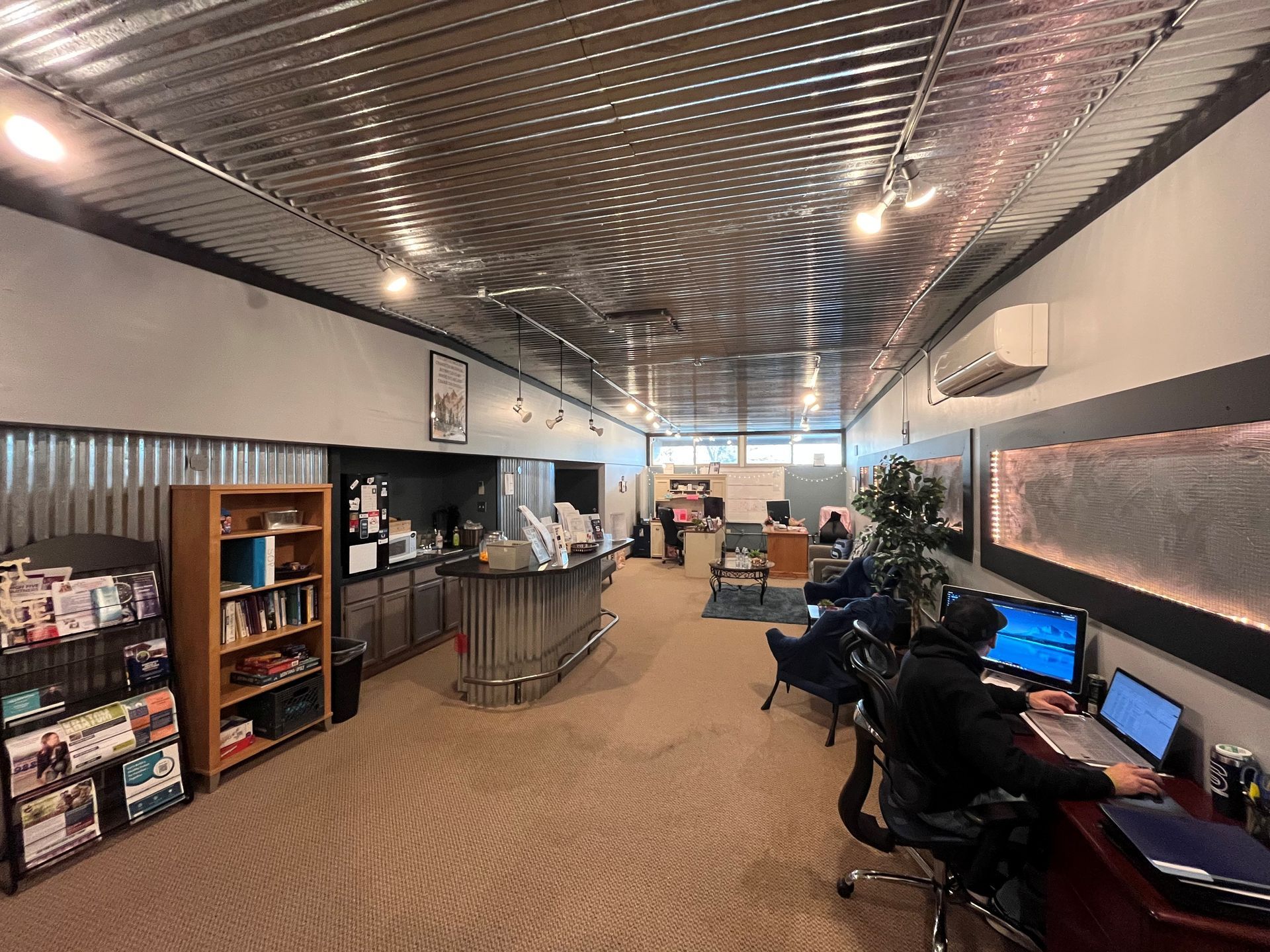 a row of folding chairs are lined up in a circle in a large room .