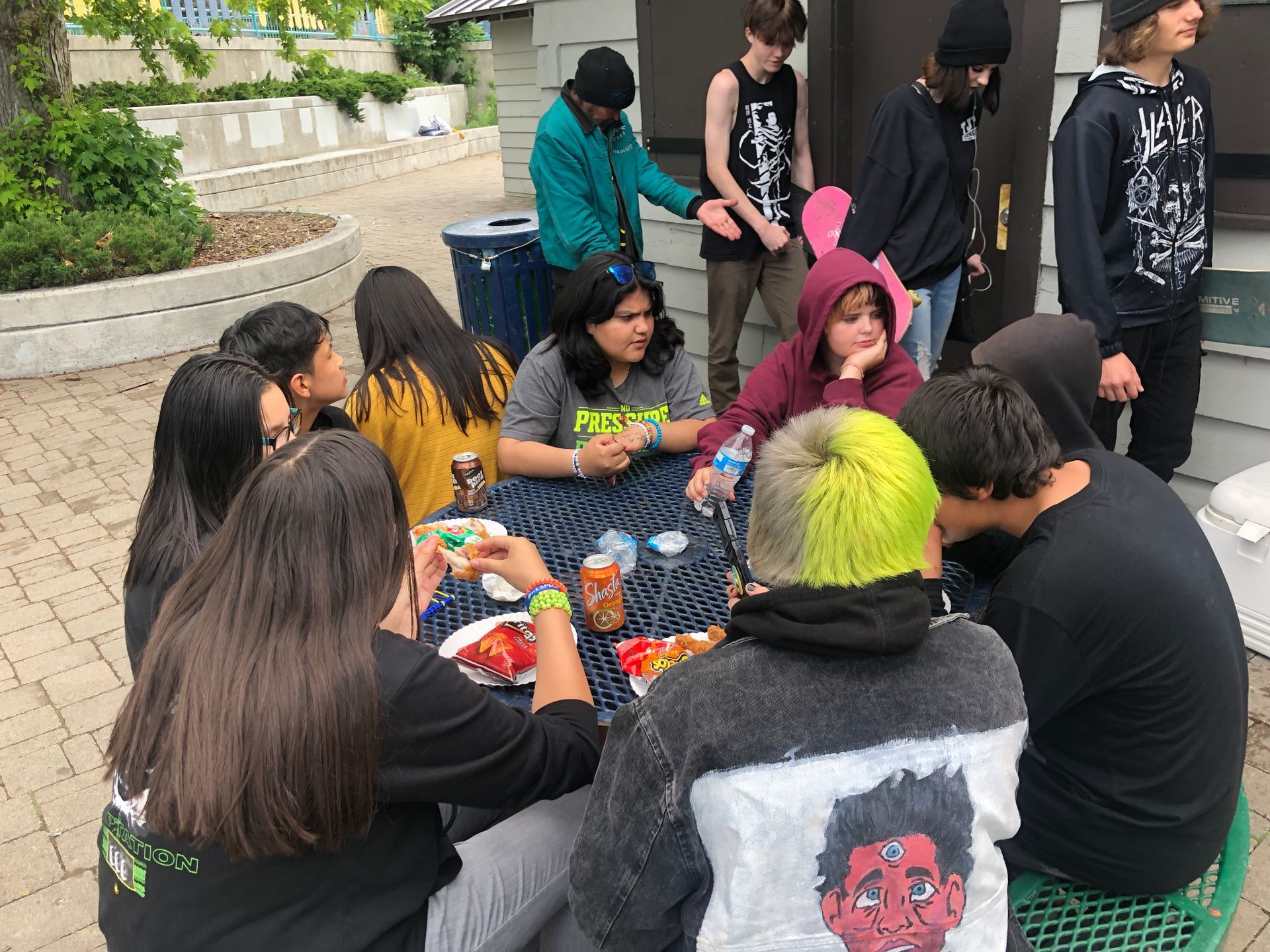Young adults sitting around a table eating lunch