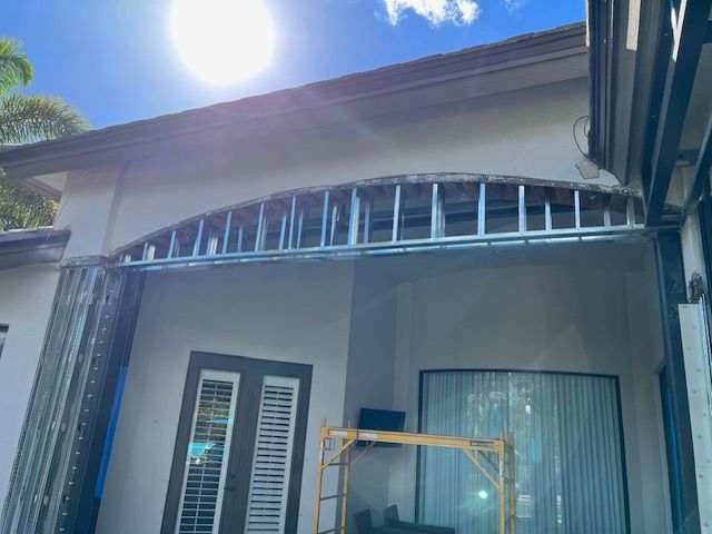 A House Under Construction with A Scaffolding in Front of It.