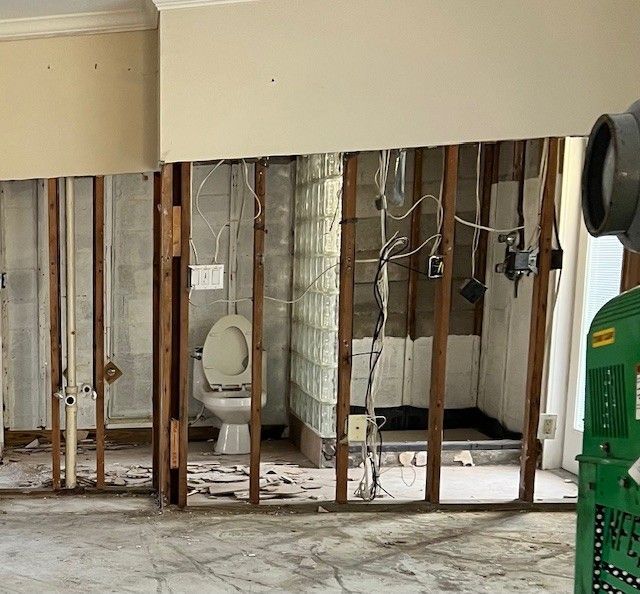 A bathroom is being remodeled with a toilet and shower.