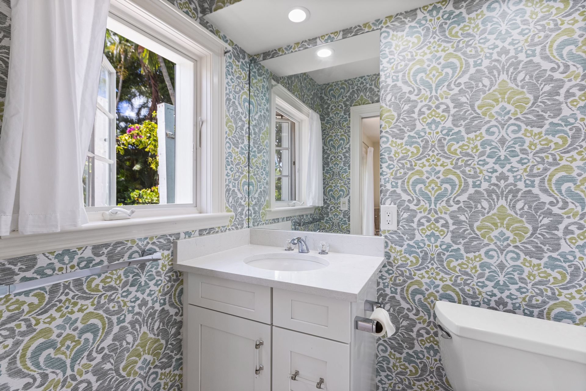 A bathroom with a sink, toilet, mirror and window — Naples, FL — Treeline Building