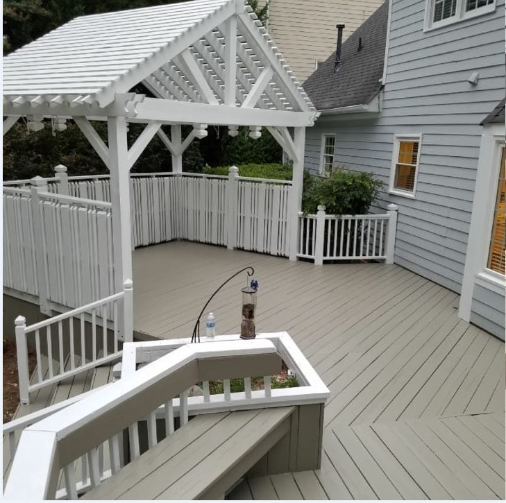 a deck with a pergola and a bird feeder on it