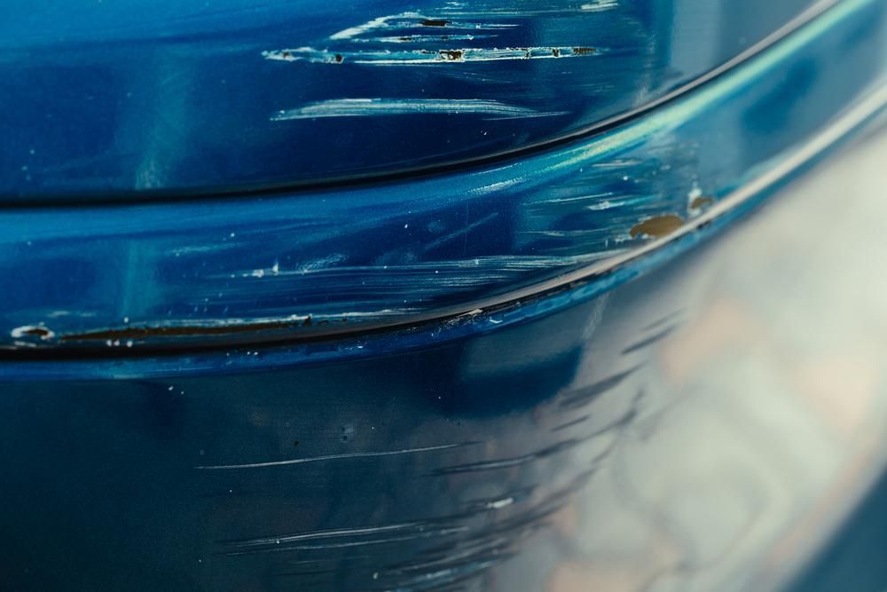 A Close Up Of A Blue Car With A Scratch On The Bumper — Platinum Paint & Panel Southport In Southport, QLD
