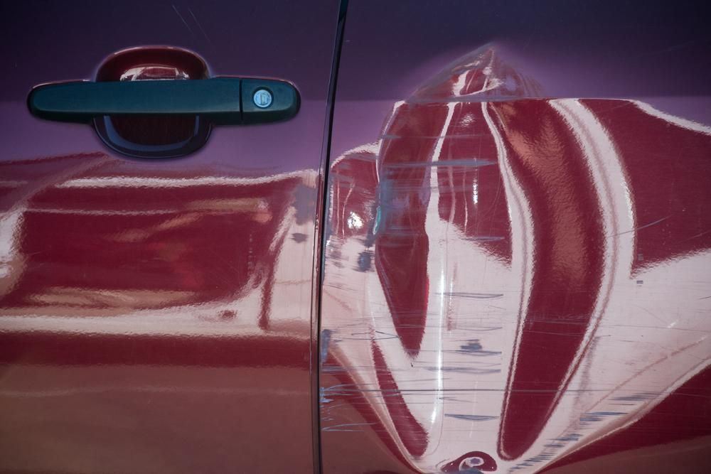 A Close Up Of A Red Car Door With A Black Handle — Platinum Paint & Panel Southport In Southport, QLD