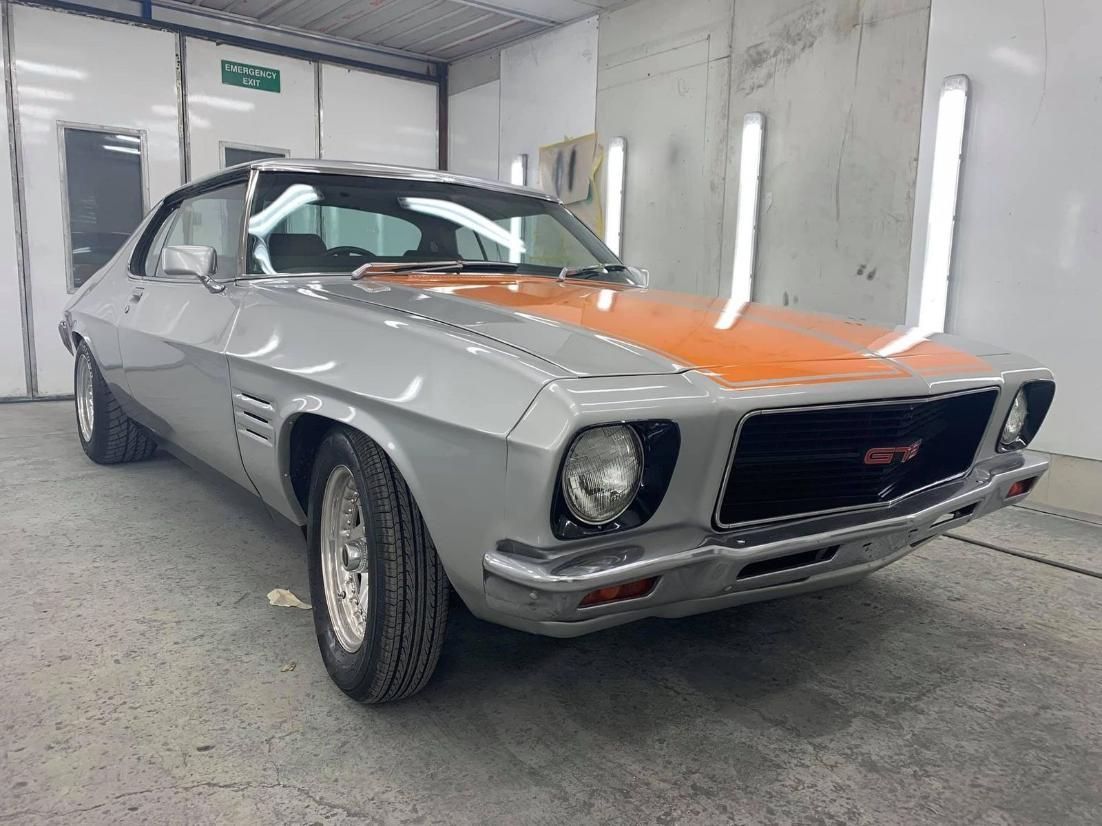 A Silver And Orange Car Is Parked In A Garage — Platinum Paint & Panel Southport In Southport, QLD