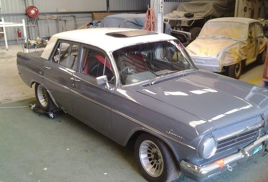 A Gray And White Car Is Parked In A Garage — Platinum Paint & Panel Southport In Southport, QLD