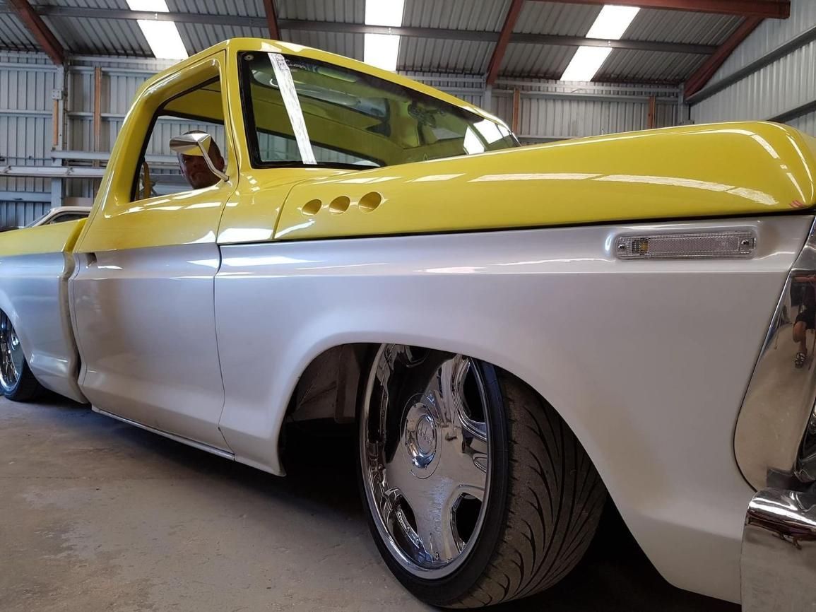 A Yellow And White Truck Is Parked In A Garage — Platinum Paint & Panel Southport In Southport, QLD