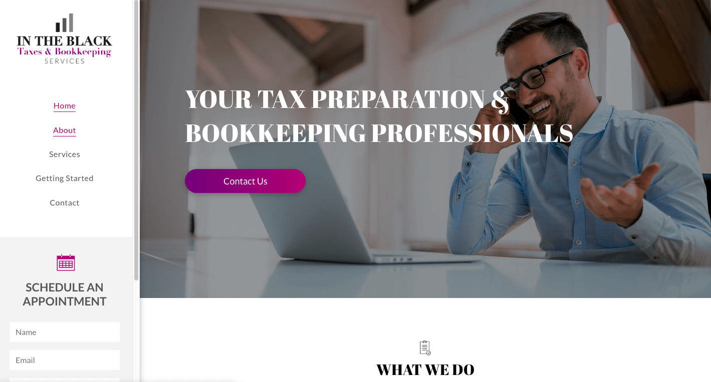 A man is sitting at a desk talking on a cell phone in front of a laptop computer.