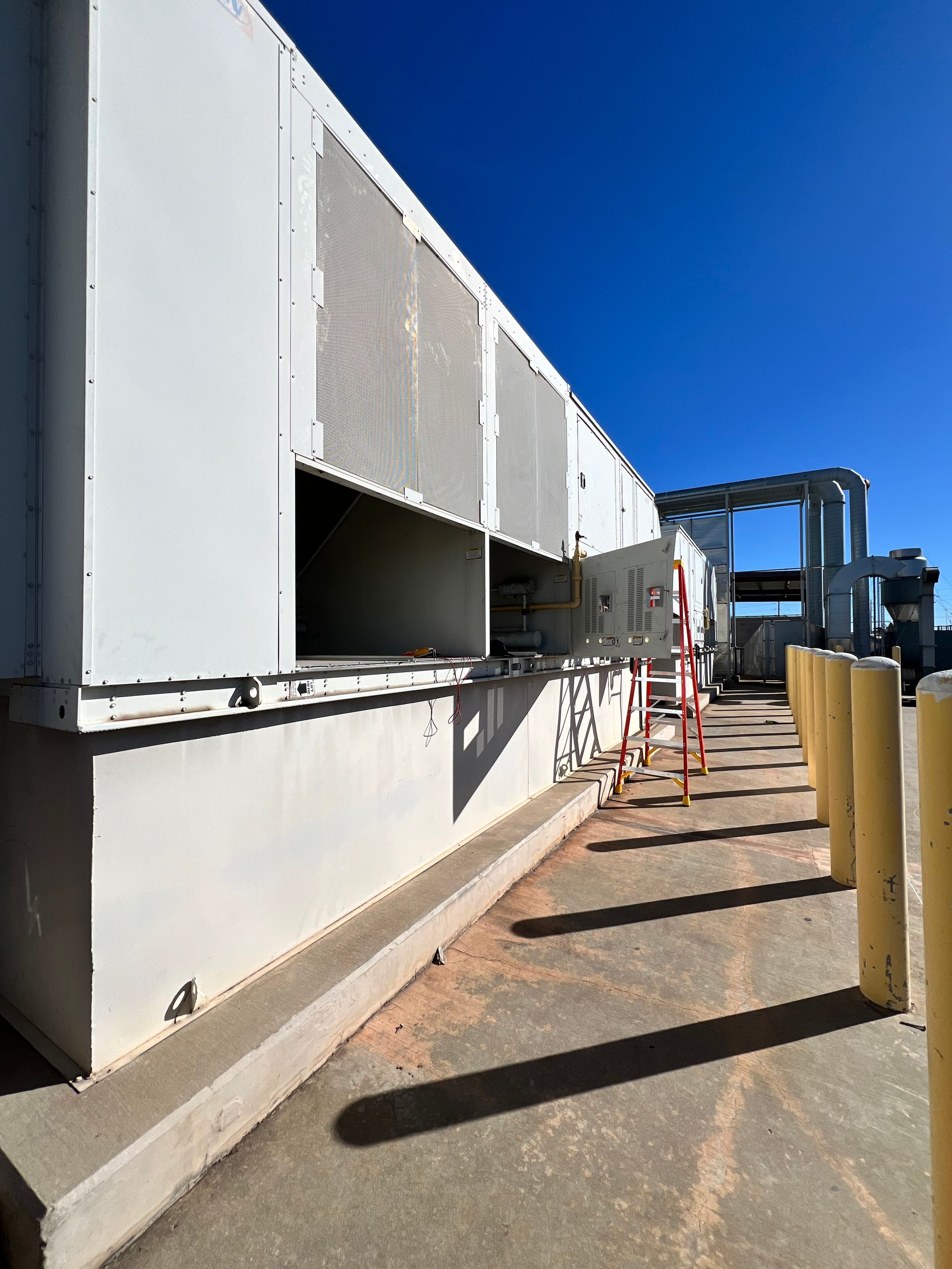 Hands of a repair person working on air conditioning unit using tools.