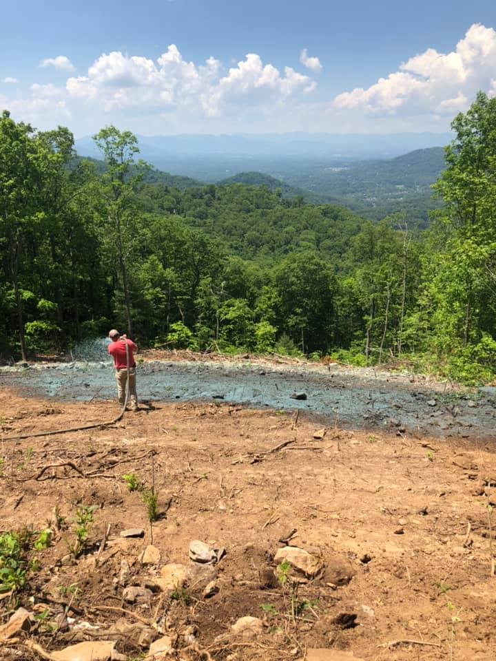 Man Sprayed Over Prepared Ground — Hendersonville, NC — Gravely Hydroseeding & Excavating
