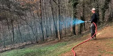 Man Using Host for Hydroseeding — Hendersonville, NC — Gravely Hydroseeding & Excavating