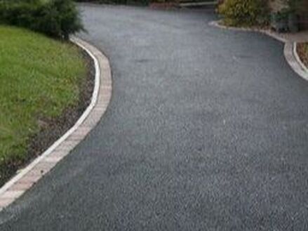 carved black tarmac driveway with block paving edging in Rotherham
