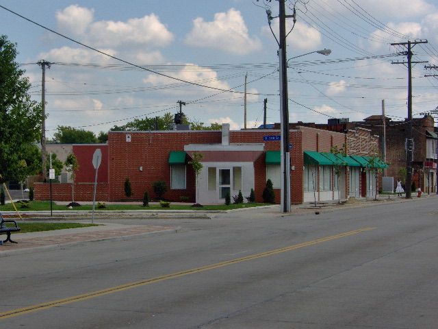 A brick building with a green awning on the side of it