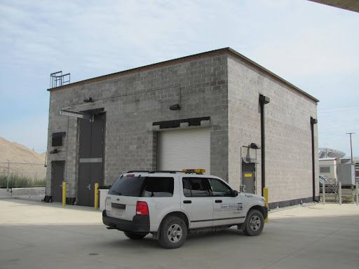 A white suv is parked in front of a building