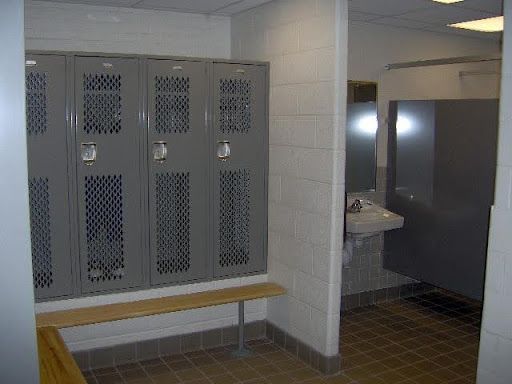 A locker room with a bench and a sink