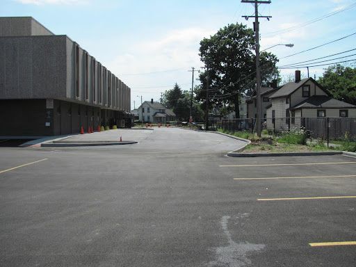 An empty parking lot with a building in the background
