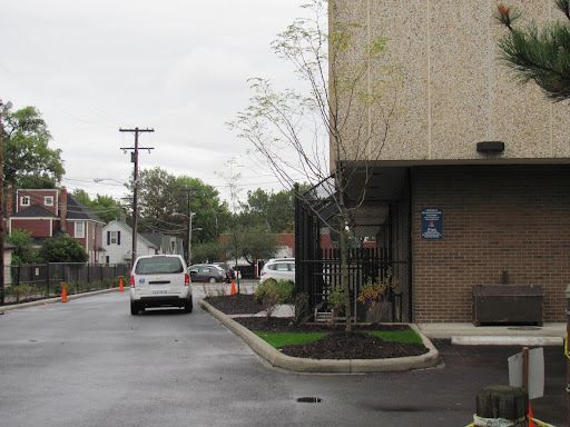 A white van is parked in front of a building