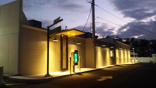 A building with a phone booth in front of it at night.
