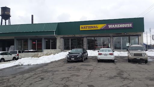 A national warehouse store with cars parked in front of it.