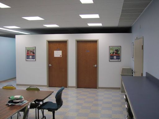 A room with a table and chairs and two doors