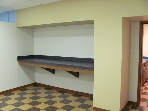 An empty room with a checkered floor and a counter