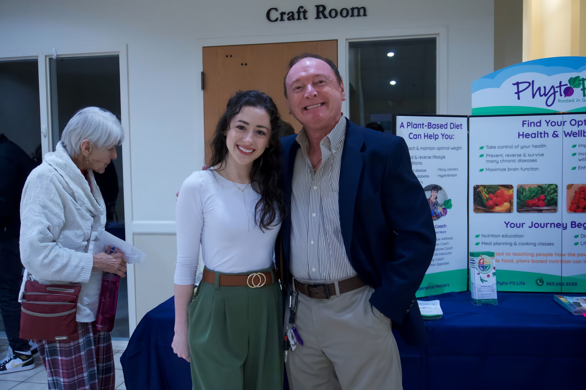 A man and a woman are posing for a picture in front of a craft room.